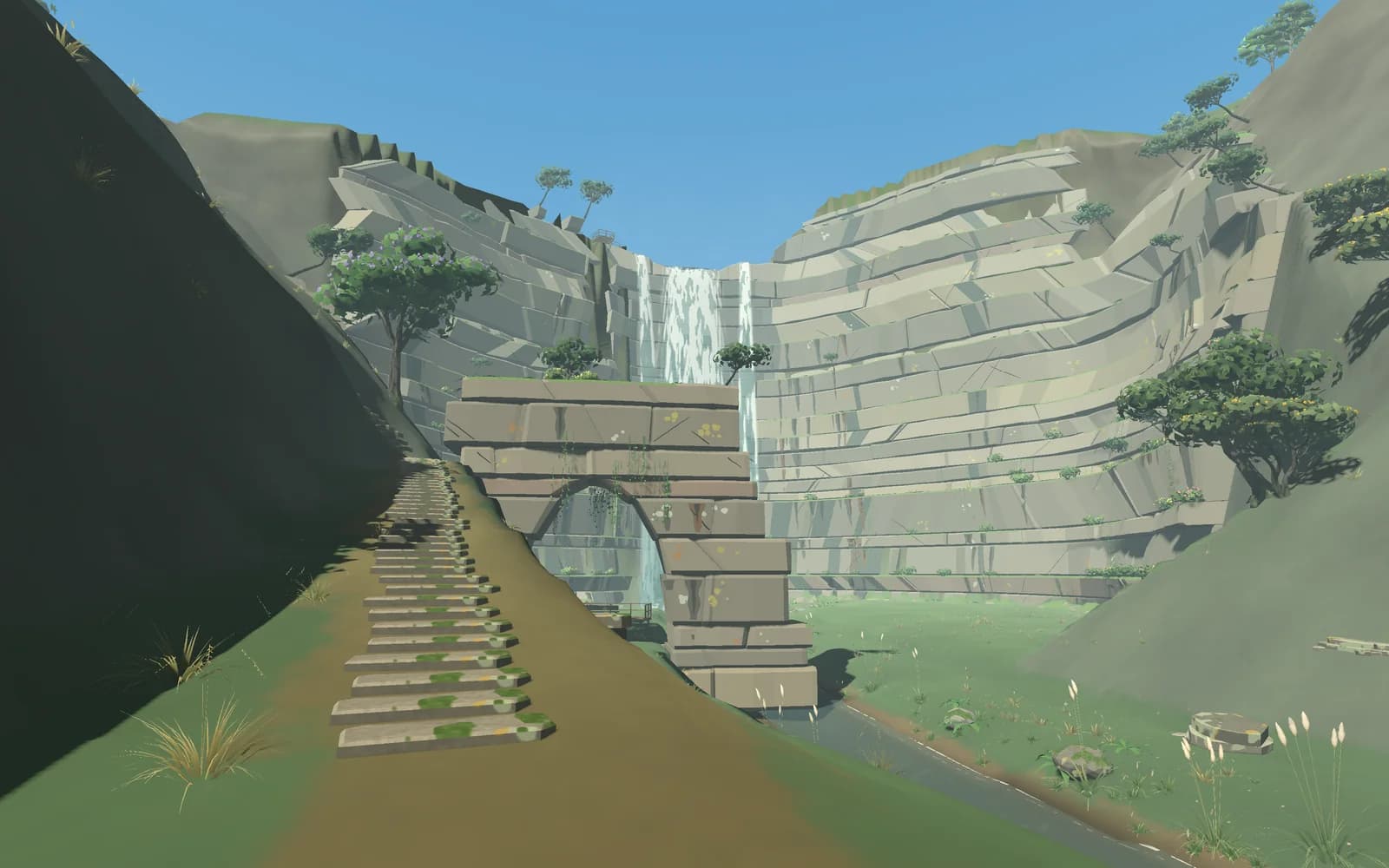 A stone arch and a stairway leading to a waterfall between cliffs
