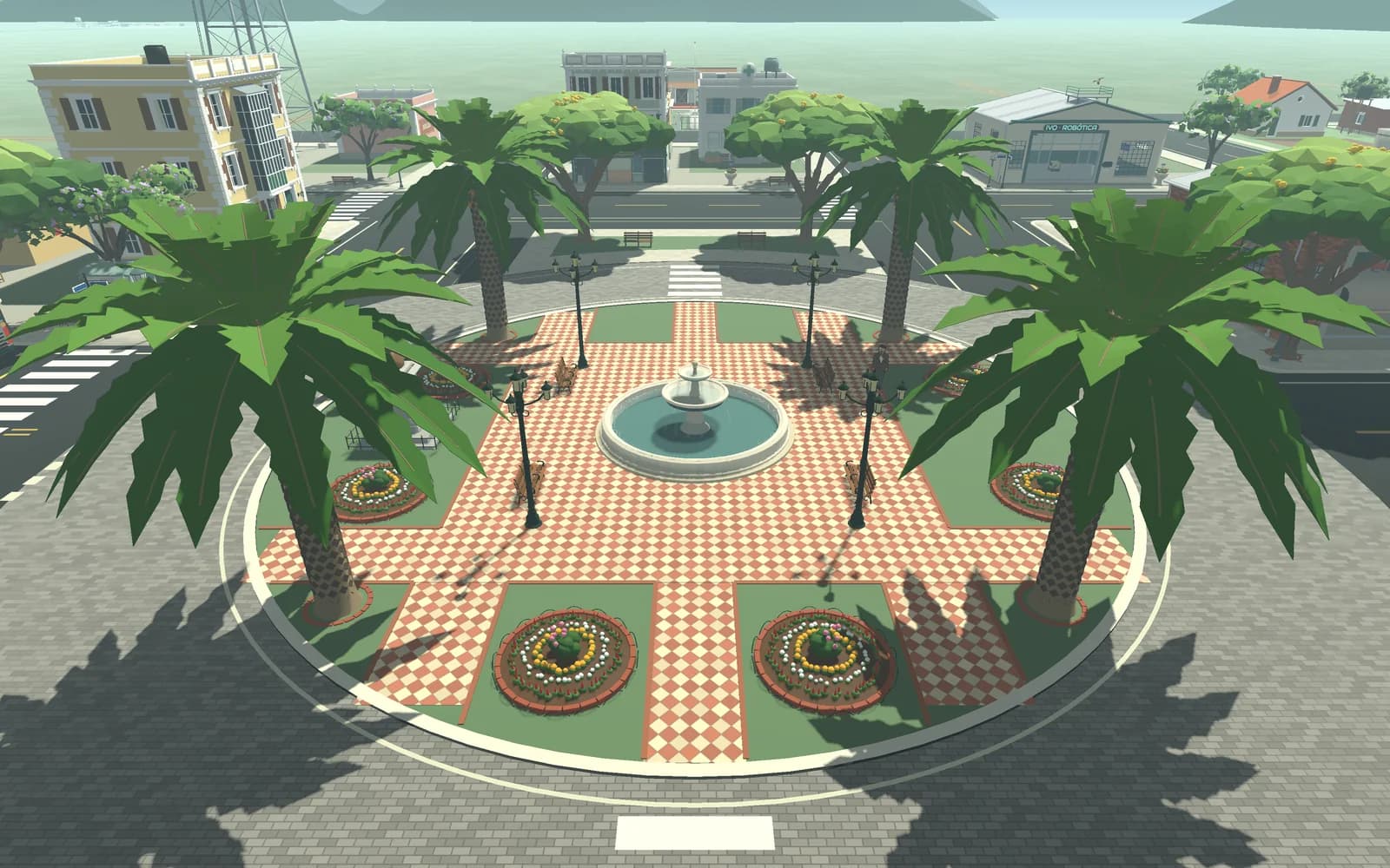 The town square from above: palms, flower beds and a fountain on a checkered plaza