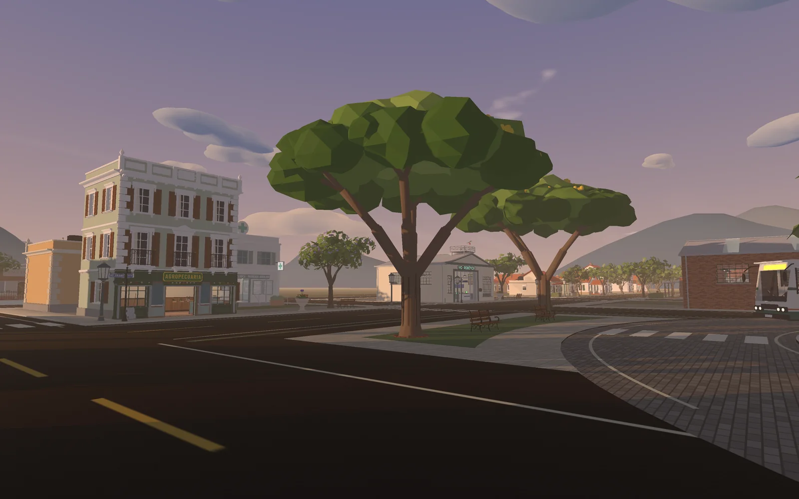 A town avenue at dusk with old buildings, plane trees and a bus